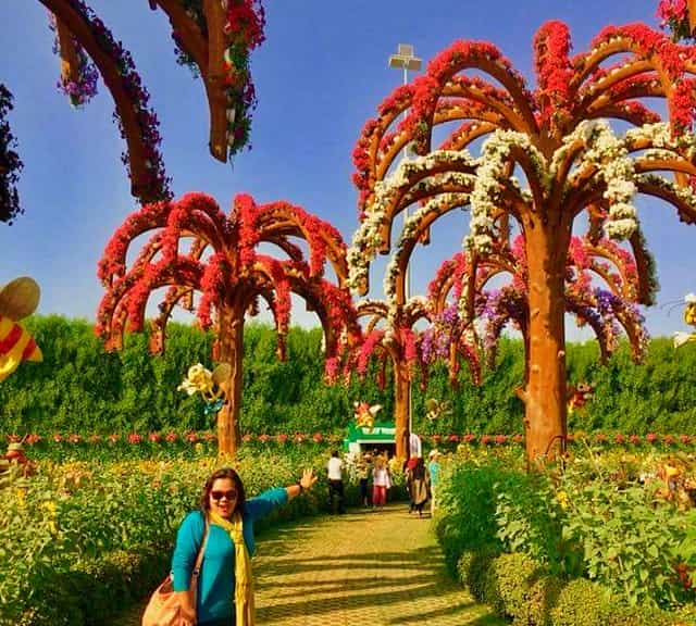 Palm Trees are decorated with Geranium flowers at the Dubai Miracle Garden