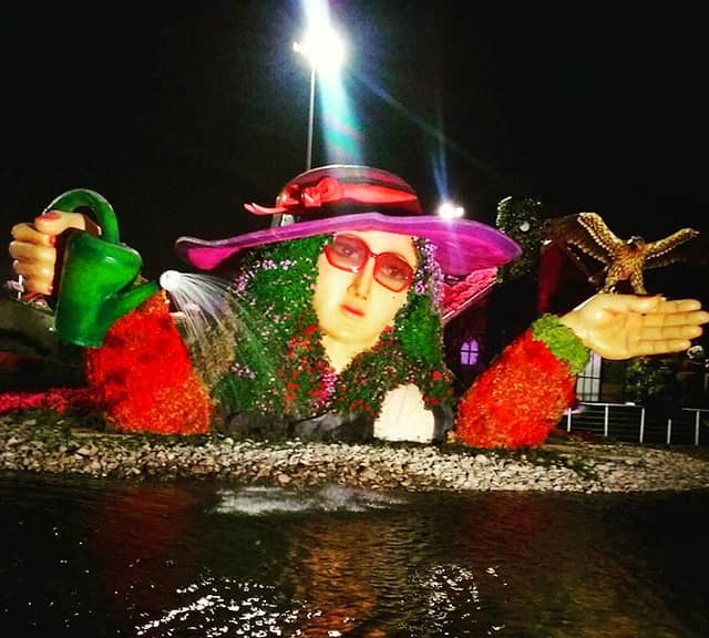 Night photograph of Flower Lady Sculpture at the Dubai Miracle Garden.