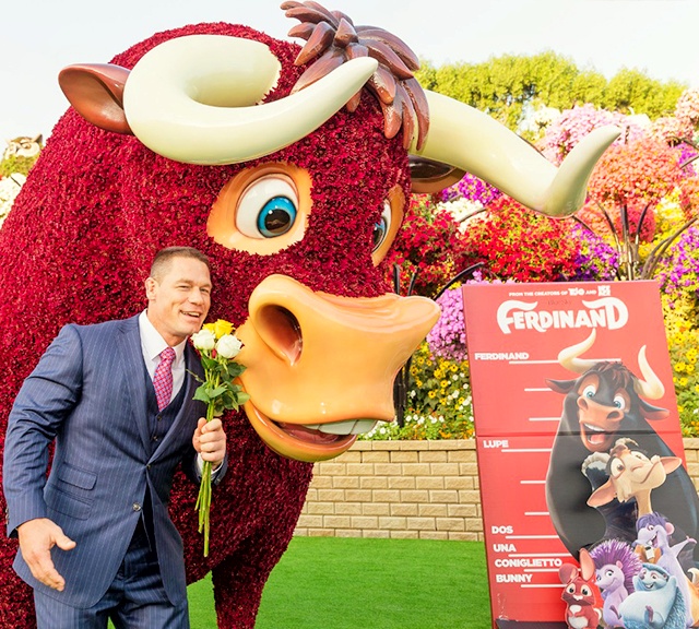 John Cena and Ferdinand smelling flowers at the Dubai Miracle Garden.